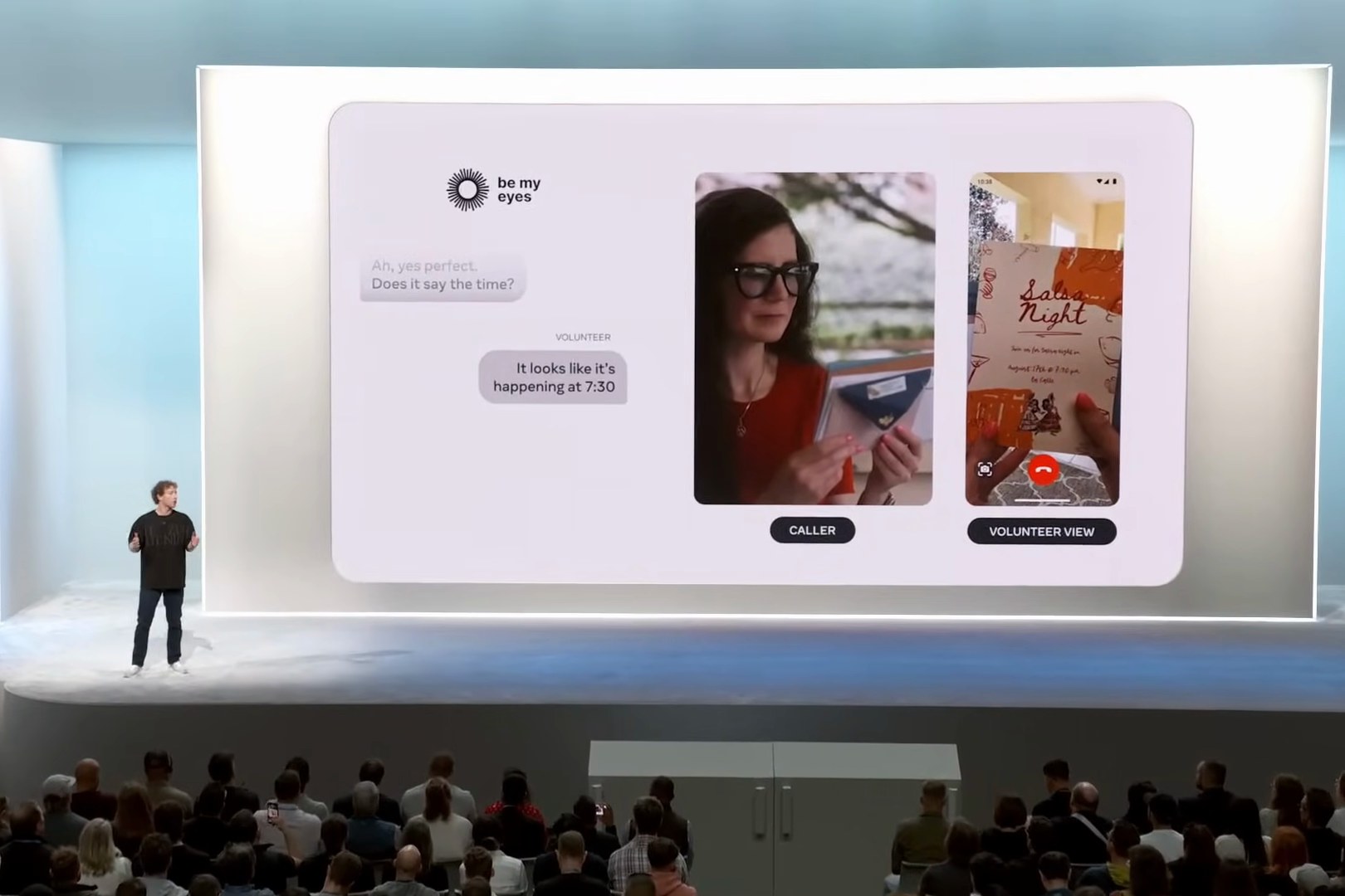 Mark Zuckerberg on the Meta Connect stage beside a giant screen showing a Be My Eyes call — the caller holding a postcard, the volunteer's phone view of it, and the volunteer's reply “It looks like it's happening at 7:30.”
